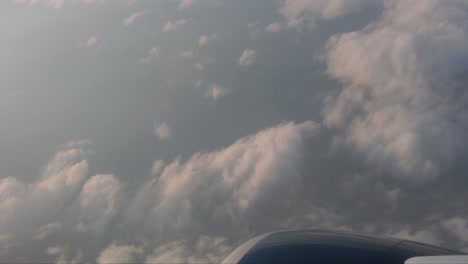 Motion-shot-from-the-window-of-an-airplane-with-beneath-and-above-during-sunset