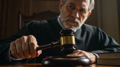 a serious judge delivering justice in the courtroom: the gavel strikes as important decisions are made with authority and wisdom