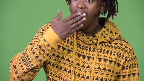 young handsome african man looking shocked