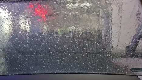 static shot of water running down windshield during car wash
