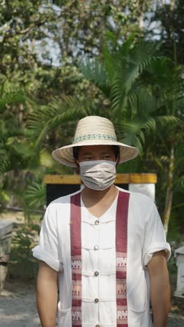 man wearing a face mask and hat