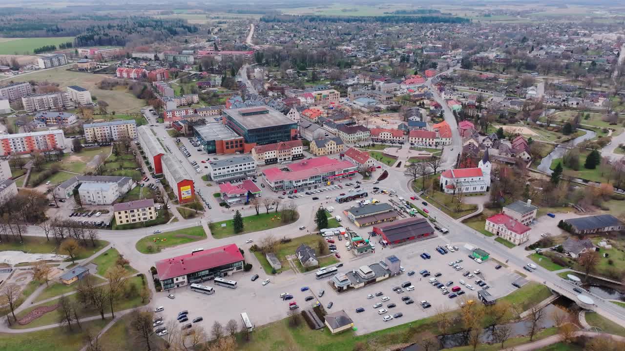 Panoramic aerial view of Saldus featuring central church, market and rooftops