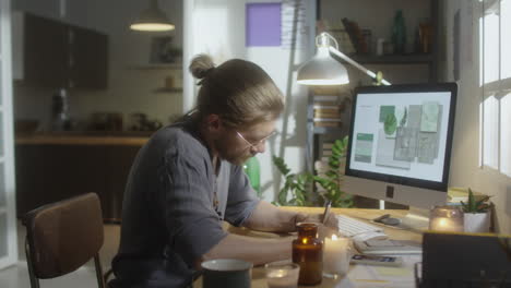 designer using computer at cozy home workplace