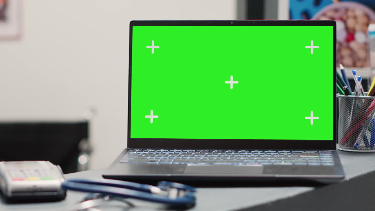 Empty front desk with green screen on pc