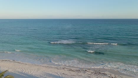 perfect tropical beach, green palm trees white sand blue ocean water and blue skies