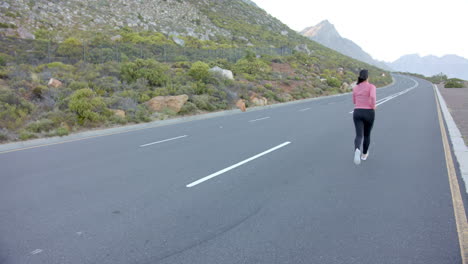 running on mountain road, woman exercising in nature with scenic view, copy space