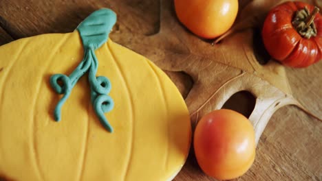 small pumpkins, tomatoes and sweet food on a wooden table 4k