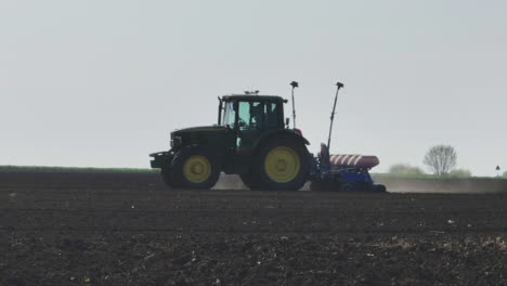 tractor planting crops in field
