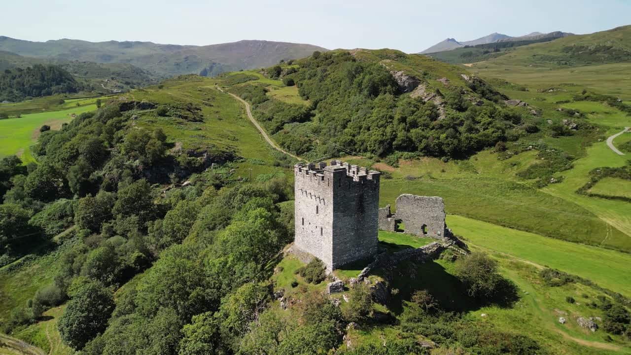 Dramatic Dolwyddelan Castle on a lovely summer afternoon - aerial drone slow clockwise rotate from far - North Wales, UK
