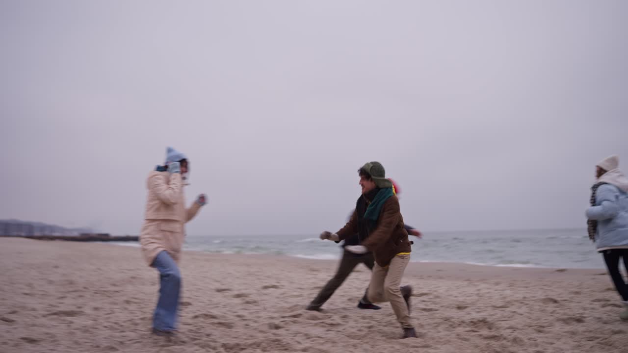 Friends having fun on a winter beach