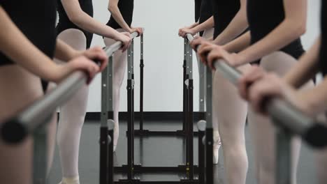 girls at ballet class at barré