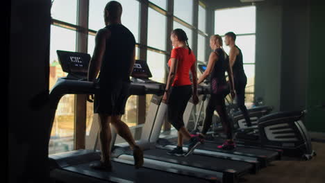 people training in a gym using treadmills and elliptical cross or training in a gym