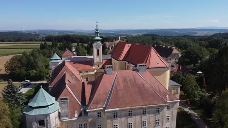 drone is flying over by a church tower from above