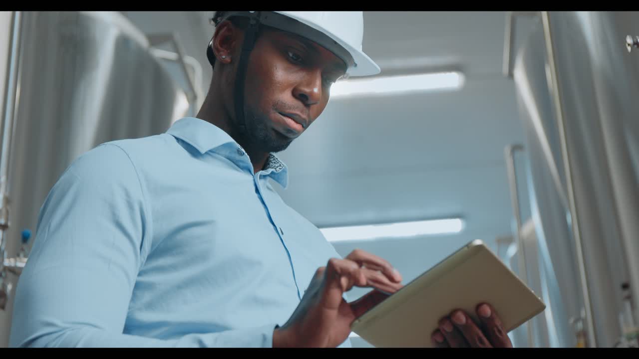 Engineer using tablet in a brewery