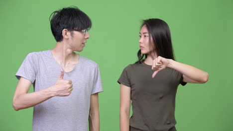 young asian couple having different decisions together