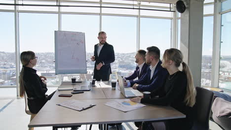 successful business speaker performs a speech using a chart. business communication among the coworkers in the office.