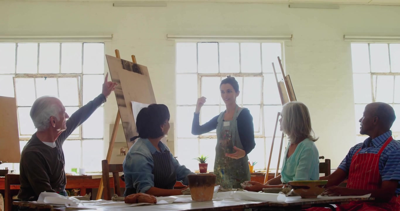 Art instructor raising hand guiding students molding clay amid social media overlays fading