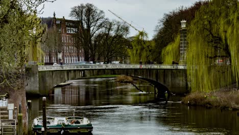 Time-lapse-of-people-and-cars-crossing-Wilhelmina-bridge-over-river-in-Den-Bosch,-the-Netherlands