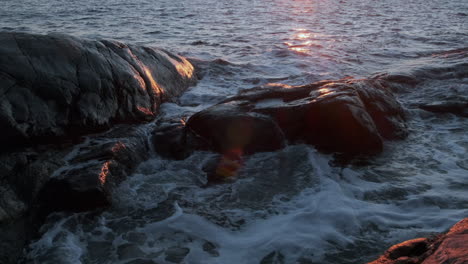 mysterious dark ocean rippling at beautiful golden sunset slow motion