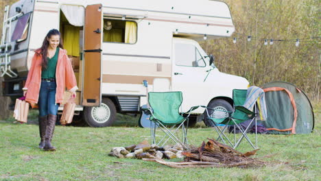 cheerful couple preparing the wood for camp fire