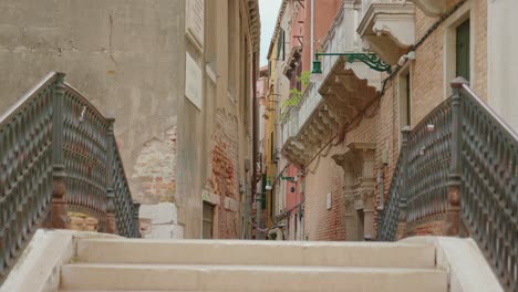 female tourist walking on brick bridge