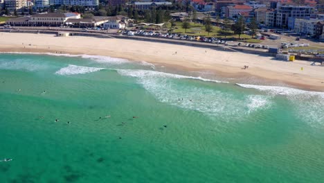 few tourist surfers on bondi beach at sydney cbd, new south wales, australia during pandemic