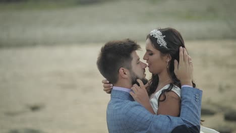 Wedding-couple-standing-near-mountain-river.-Groom-and-bride-in-love