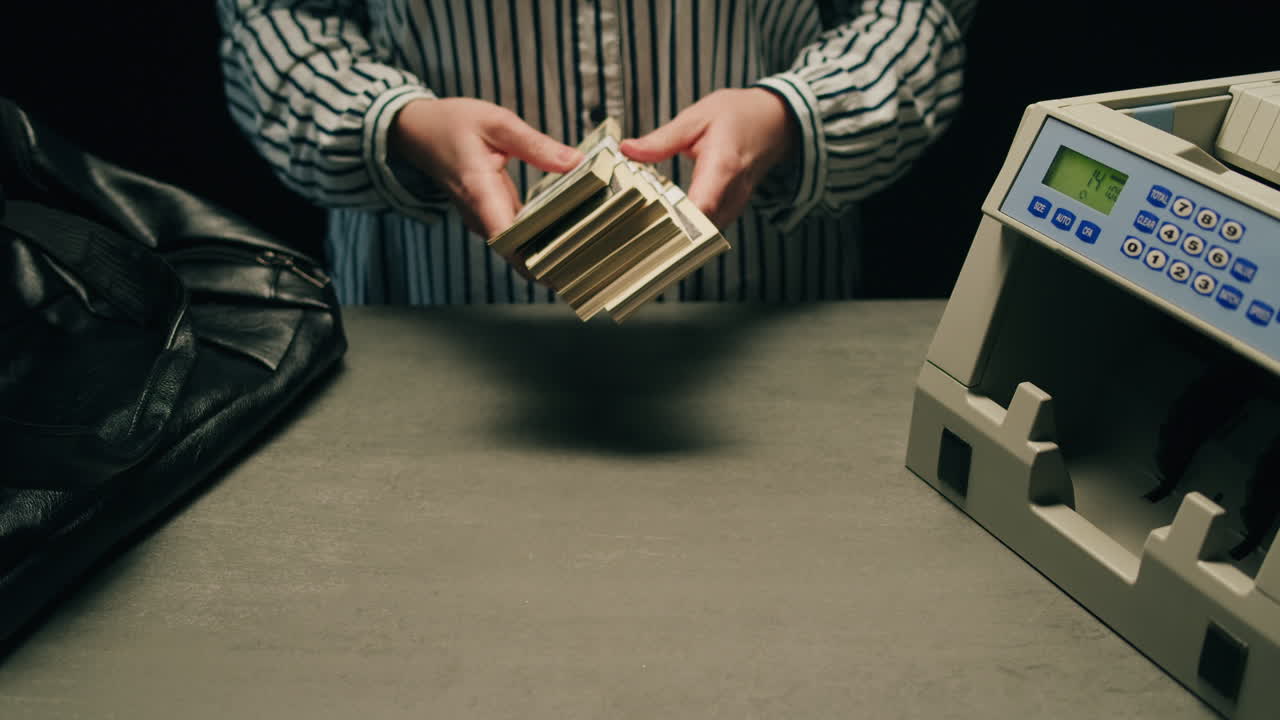 Specialised police officer Counting dollar banknotes in crime lab, conceptual image. High quality 4k footage