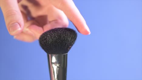 close-up time lapse shot of a wide, fluffy cosmetic brush.