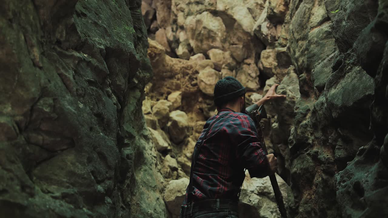 Man Climbing Rocks in Canyon