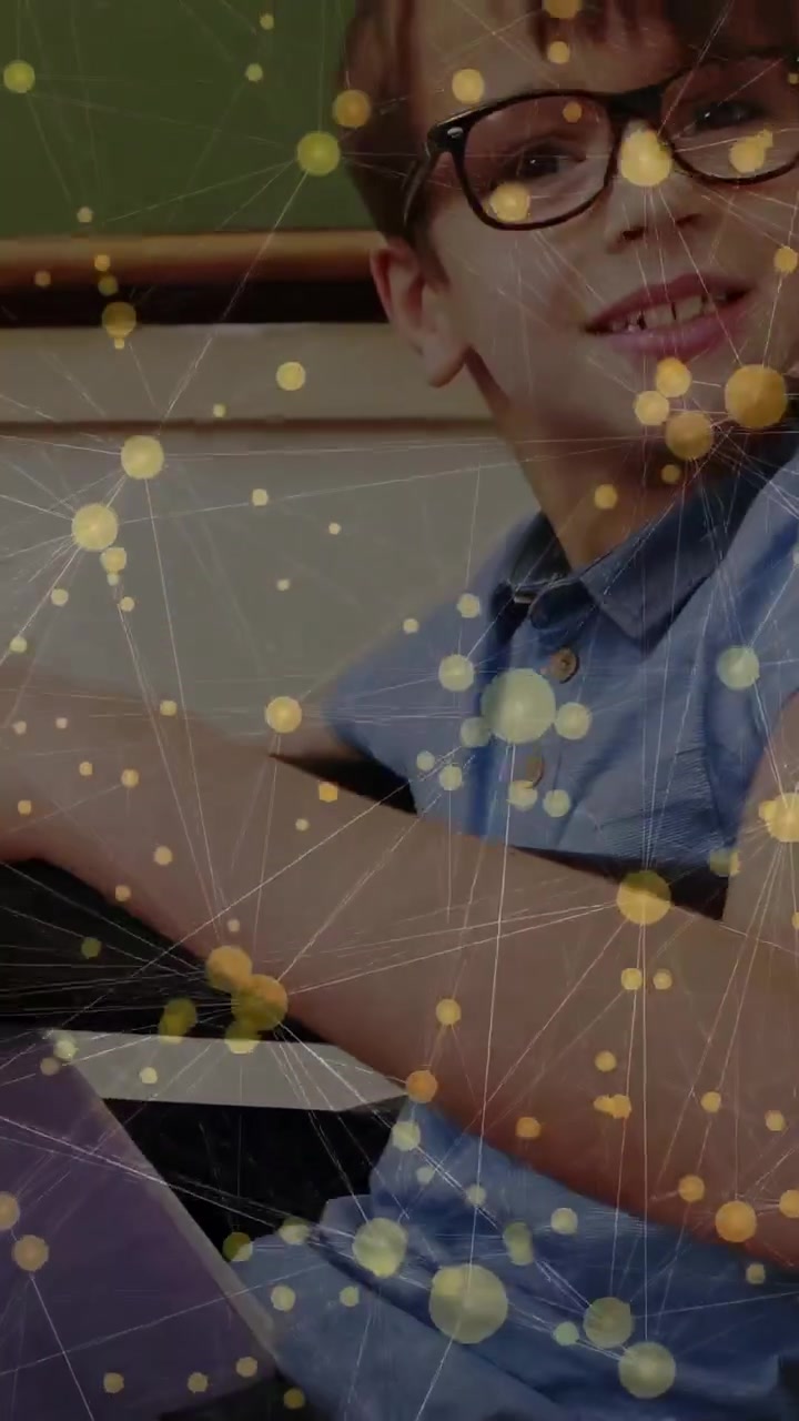 Vertical video: Cam shifting yellow nodes overlaying school revealing boy turning to cam smiling