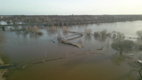 bridge partially immersed in flooded ems river in meppen, germany