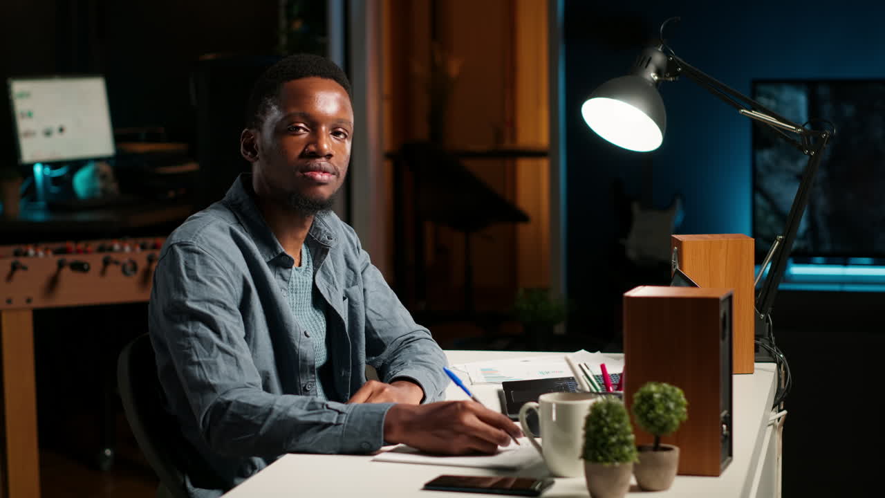 POV of african american guy attending an online conference from his home office
