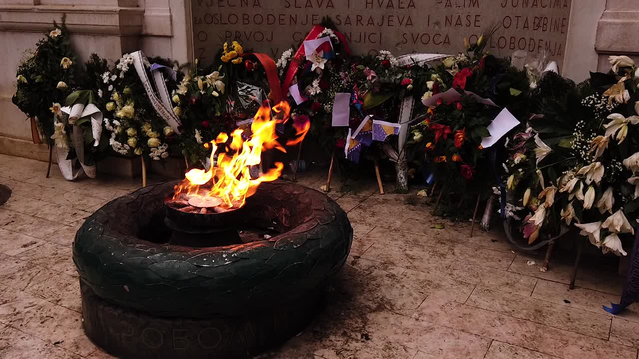 The Eternal flame in Sarajevo, a memorial to the military and civilian victims of the World War Two. Street, monument. Camera pan up