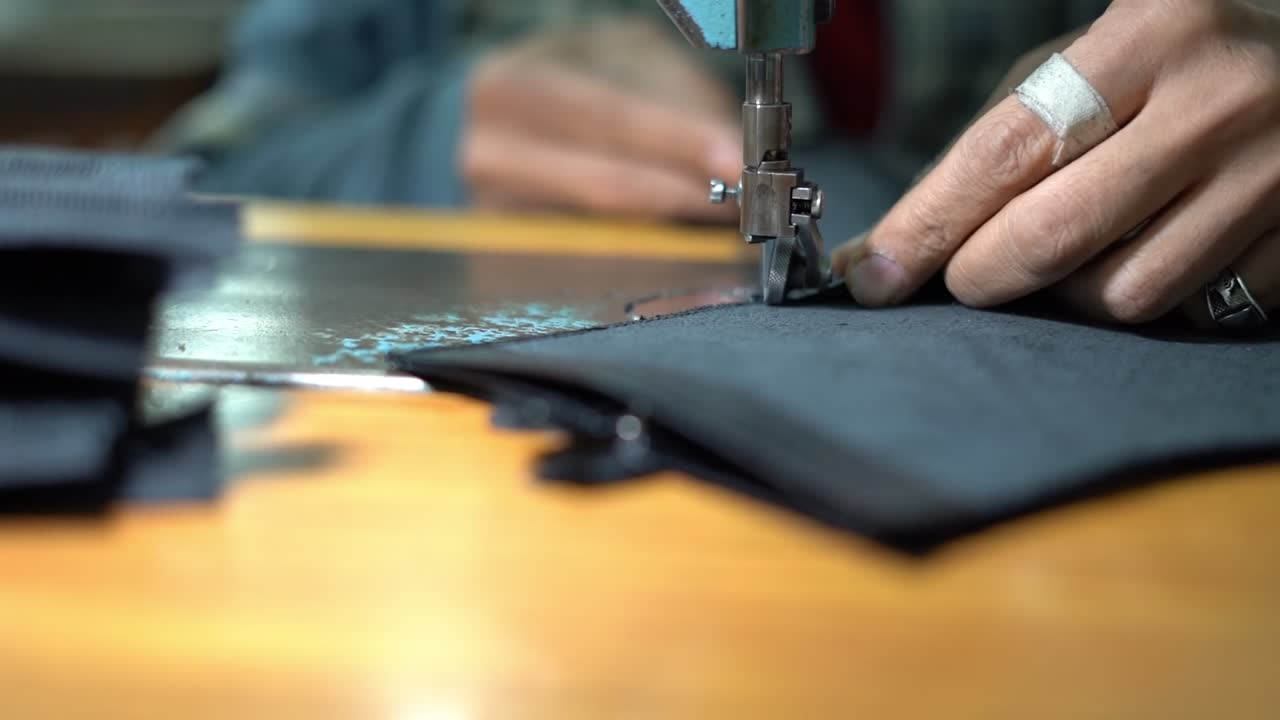 a craftsman handmade a bag by Sewing machine, close up shot, insert shot