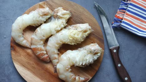 raw shrimp on a wooden cutting board