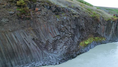 Aerial:-Circle-detailed-shot-of-Studlagil-River-Canyon-with-basalt-columns-in-Northeast-Iceland