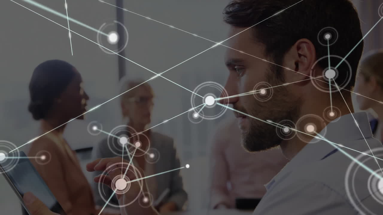 Man using tablet in modern business technology meeting, interacting with digital network overlay