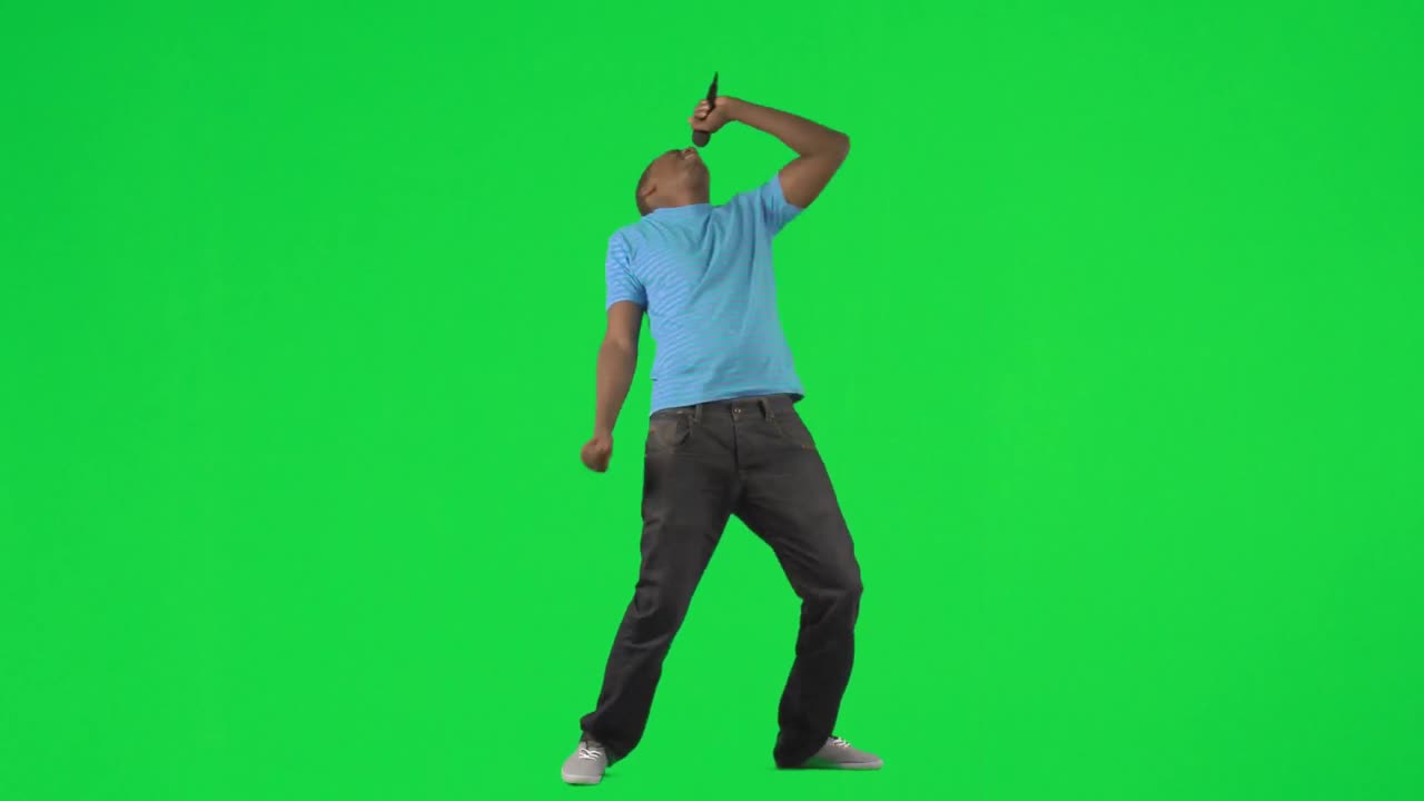 AfroAmerican man singing and dancing against green screen
