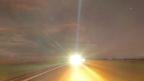 cars headlight movement on a road with night sky, drive-lapse shot