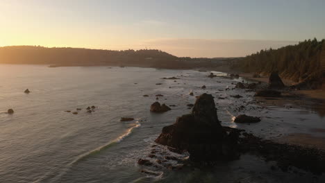 ocean waves crashing on rocky beach during sunset near port orford, oregon