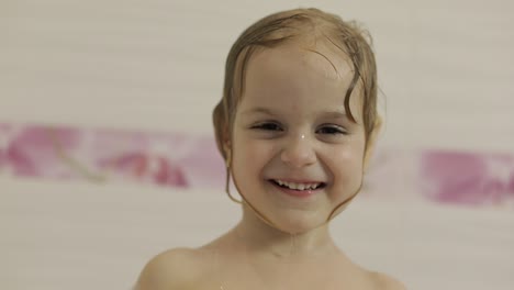 Attractive-three-years-old-girl-takes-a-bath.-Cleaning-and-washing-hair