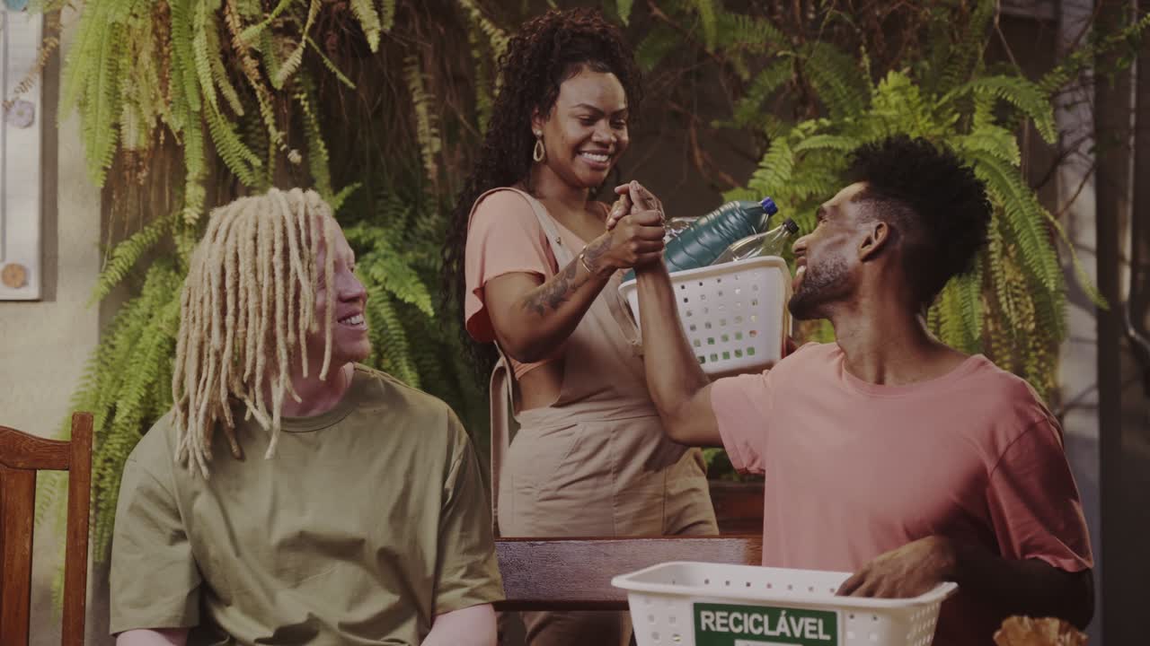 Friends actively participating in plastic bottle recycling