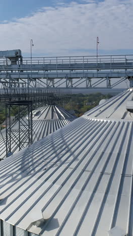 huge industrial metal containers. big factory metal constructions. aerial view. vertical video