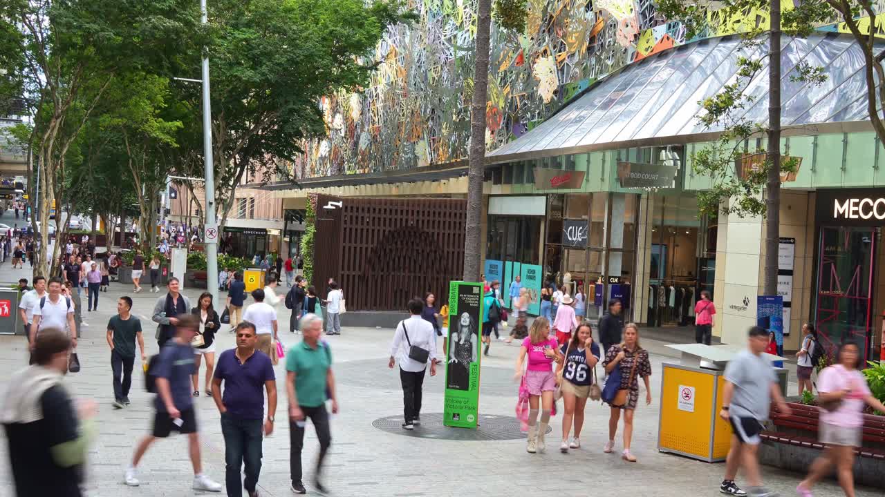 Vibrant urban street scene of downtown Brisbane city on the weekend, shoppers shopping at Queen street mall, people strolling at the outdoor pedestrian shopping precinct, fast motion time-lapse shot.
