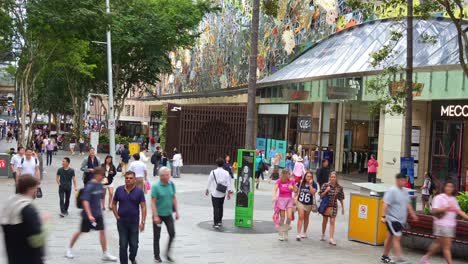 vibrant urban street scene of downtown brisbane city on the weekend, shoppers shopping at queen street mall, people strolling at the outdoor pedestrian shopping precinct, fast motion time-lapse shot.