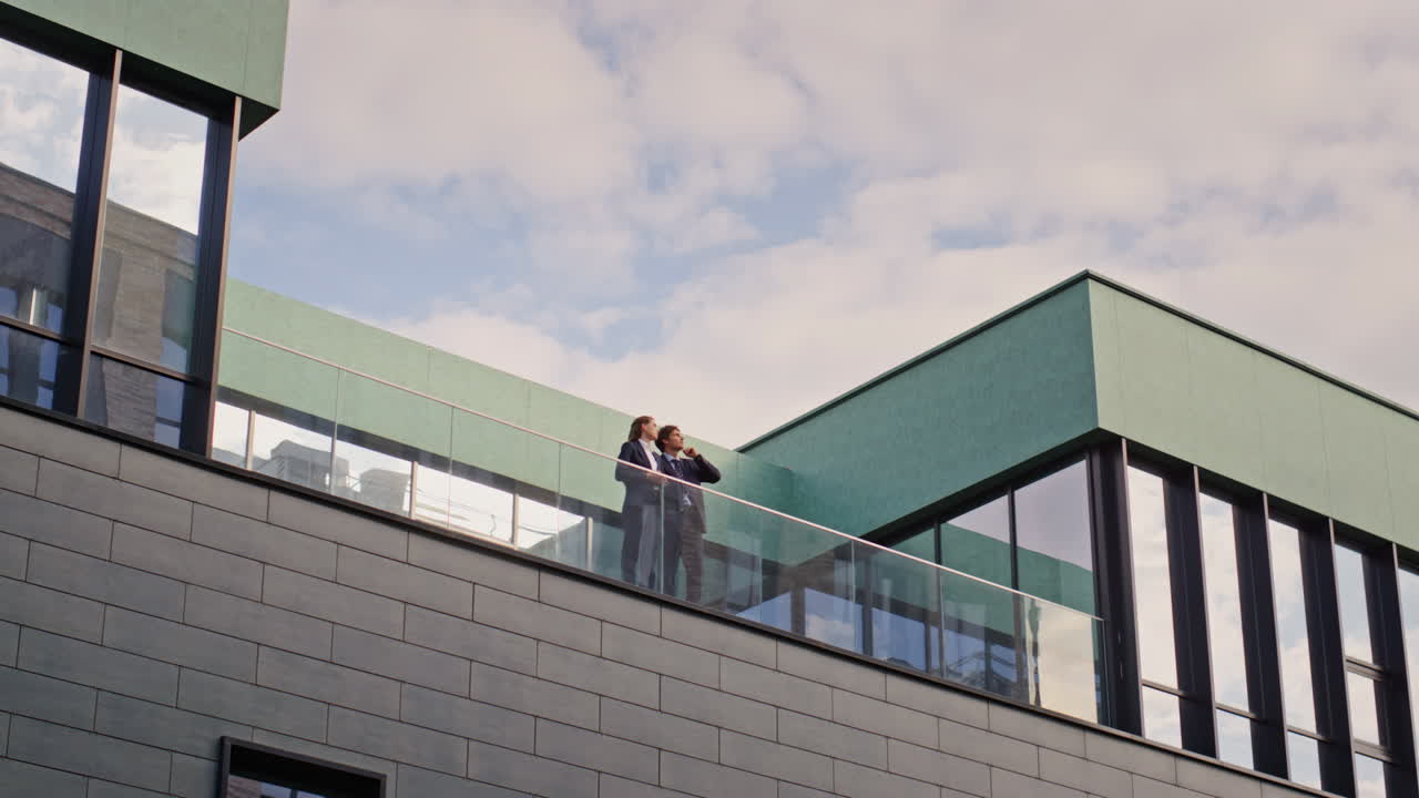 Business colleagues talking balcony office building. Partners discussing work