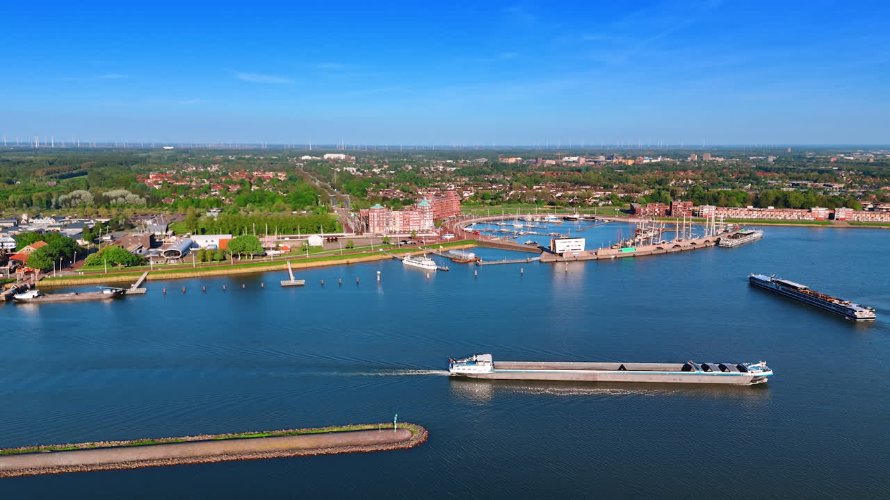 Empty barge moving slowly by the lake waterscape. Aerial perspective on the scenery of Lelystad, the Netherlands.