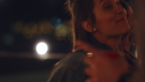 happy hispanic woman dancing to lively rooftop party music enjoying weekend celebration hanging out with friends in urban city at night