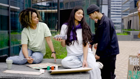 Two-Young-Women-Finishing-Their-Board-While-Their-Friends-Go-To-Help-Them